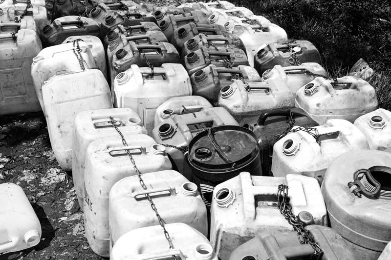 Queue and Rush for Drinking Water - Containers queued up in advance for collecting drinking water from a group water connection in Mumbai, Maharashtra